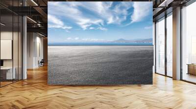 Asphalt road and sea scenery, road and sky background. Wall mural