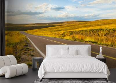 Asphalt road highway and beautiful grassland with mountain nature landscape in autumn. Road trip. Wall mural