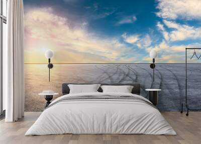 Asphalt road pavement and dramatic sky at sunset Wall mural