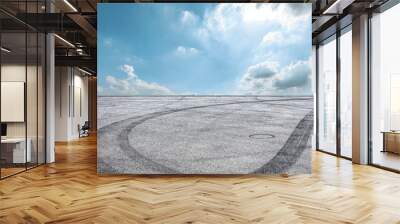 Car track square and blue sky with white clouds on a sunny day Wall mural