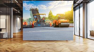 Construction site is laying new asphalt road pavement,road construction workers and road construction machinery scene. Wall mural