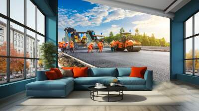 Construction site is laying new asphalt road pavement,road construction workers and road construction machinery scene. Wall mural