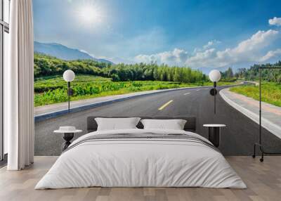 Country road and green forest with mountain natural landscape on a sunny day Wall mural