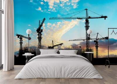 Crane and building construction site at sunset Wall mural