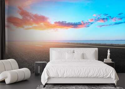 empty asphalt highway and blue sea nature landscape at sunset Wall mural