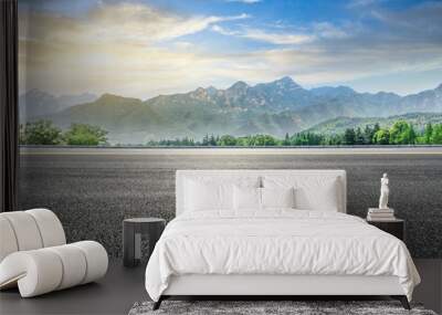 Empty asphalt highway and green mountain nature landscape at sunset Wall mural