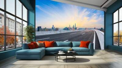 Empty asphalt highway and modern city skyline in Shanghai at sunset,China Wall mural