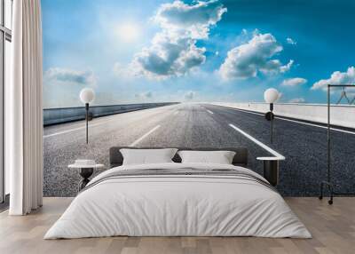 Empty asphalt road and blue sky with white clouds.Road background. Wall mural