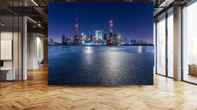 Empty asphalt road and city skyline with modern commercial buildings in Shanghai at night, China. Wall mural