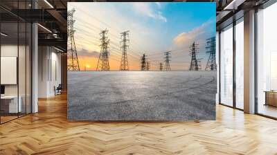 Empty asphalt road and high voltage power tower landscape Wall mural