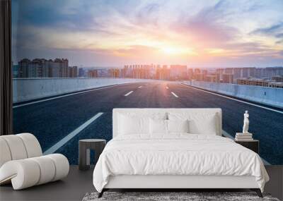 Empty asphalt road and modern city skyline with building scenery at sunset. high angle view. Wall mural