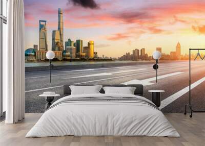 Empty asphalt road through Shanghai business district at sunset Wall mural