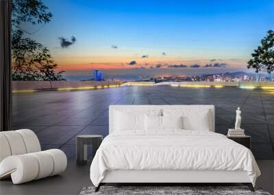 Empty square floor and city skyline by the sea at sunset Wall mural