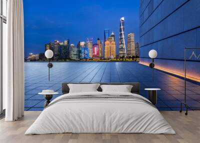 Empty square floor and city skyline with modern building at night in Shanghai, China. Wall mural