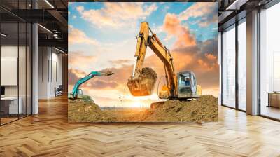 excavator in construction site on sunset sky background Wall mural