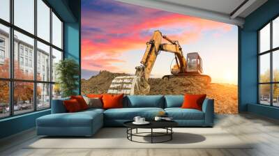 excavator in construction site on sunset sky background Wall mural