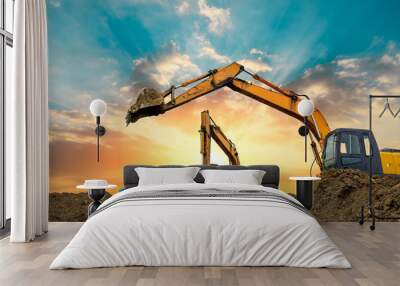 Four excavators work on construction site at sunset Wall mural