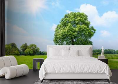 green grass and tree under the blue sky Wall mural