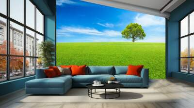 Green grass and tree under the blue sky Wall mural