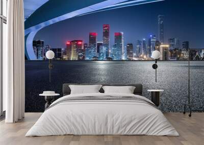 Panoramic skyline and modern commercial buildings with empty road. Asphalt road and cityscape at night. Wall mural