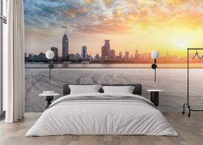 Shanghai bund city skyline and empty asphalt road ground at sunset Wall mural