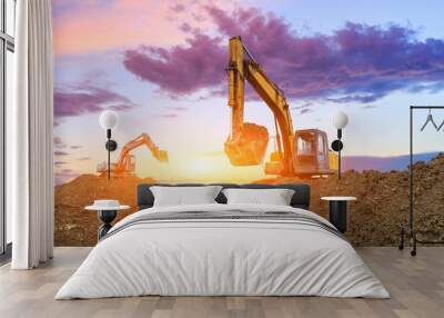 Two excavators work on construction site at sunset Wall mural