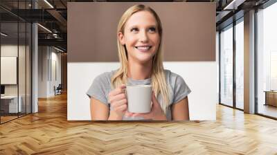 Cheerful blonde girl lady holding fresh hot coffee smiling saying thank you to boyfriend. Happy morning waking up in the morning in good mood. Wall mural