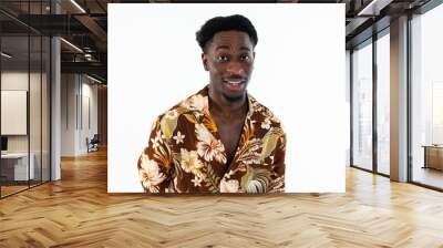 Curious african american man looking at camera surprised talking wearing colorful shirt standing n white background isolated in studio. Wall mural