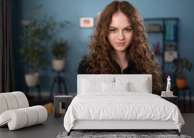 Portrait of young attractive brunette teenage girl with curly hair. Wall mural