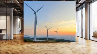  An elegant wind farm set against a dramatic sunset, with the turbines gracefully rotating in the foreground.  Wall mural