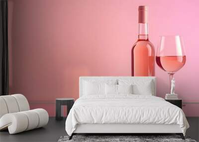 A wine bottle and glass filled with ros?(C) wine on a glass table with a solid pink background, creating a soft and inviting atmosphere. Wall mural