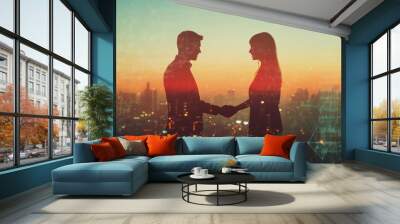 Silhouettes of a Man and Woman Shaking Hands Against a City Skyline Wall mural