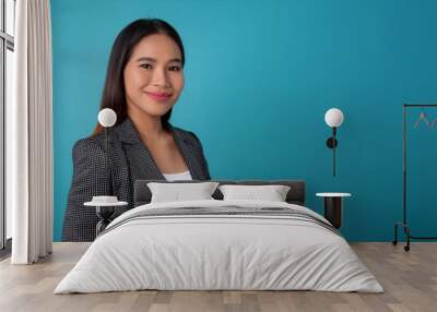 portrait of an Asian woman in a formal pose facing the camera with a plain color background Wall mural