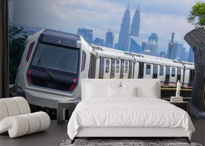 Malaysia Mass Rapid Transit (MRT) train with a background of Kuala Lumpur cityscape. People commute with MRT as transportation to work, school, travel, and shopping. Wall mural