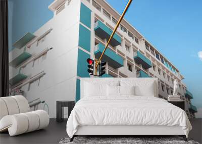 White and aqua mint building with blue sky and a traffic light Wall mural