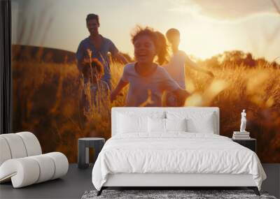 Happy family running in the field at sunset, laughing and playing together. Cinematic scene with natural light of a sunny day near sunset in the summer. Soft colors with a blurred background. Wall mural