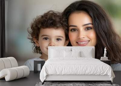 young mom and son smiling and looking at camera with blur background Wall mural