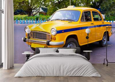 Local yellow taxi waiting for passengers in taxi stand near Victoria Memorial. Yellow taxi is oldest Taxi in Kolkata city and it is also a tourist attraction for ride. Wall mural