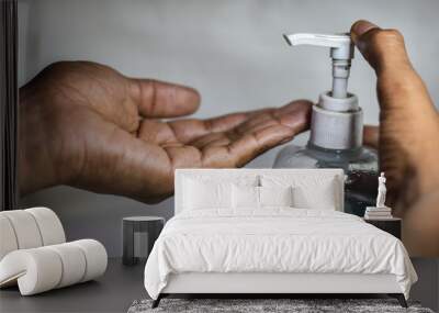 indian man cleaning a hand with hand sanitizer on a white background, Hand Snitizer  Wall mural