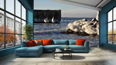 Waves crahing on icy rocks Wall mural