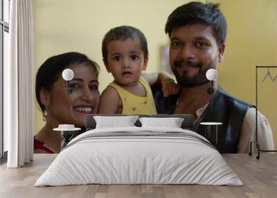 Happy Indian Bengali family with smiling mom, dad and baby. Indian lifestyle Wall mural