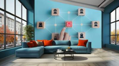 Strategic Business Network Hand Selecting Red Storefront Icon from Interconnected Blocks on Pastel Blue Background Wall mural