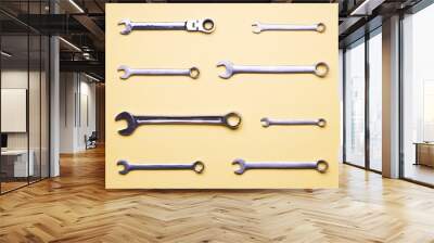 A few wrenches on a yellow background. Wall mural