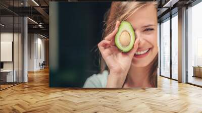 Smiling girl with an avocado Wall mural