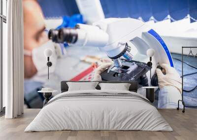 chemist researcher working with microscope for forensic evidence Wall mural