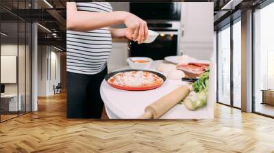 close up details of pregnant woman making home pizza Wall mural