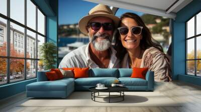 Couple in love sitting on yacht deck while sailing in the sea. Handsome man and beautiful woman having romantic date. Luxury travel concept. Wall mural