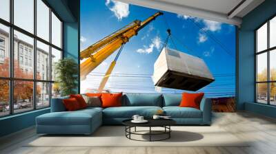 industrial crane operating and lifting an electric generator Wall mural