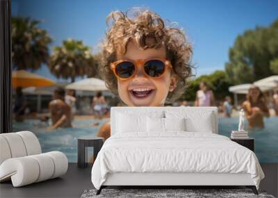 Portrait of happy child playing in pool. Smiling kid in water, playing with ball and splashing Wall mural