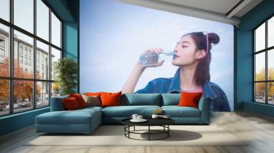 healthy girl's drinking water in the bottle , drink for thirstily for Refreshing Wall mural